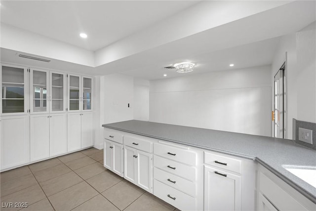 kitchen with sink, white cabinetry, and light tile patterned floors