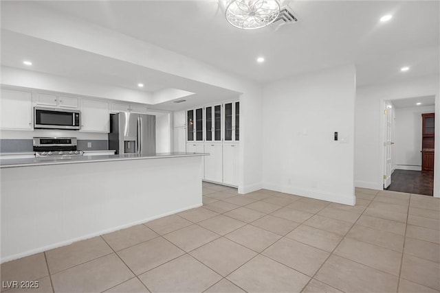 kitchen featuring white cabinetry, light tile patterned floors, and appliances with stainless steel finishes