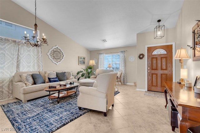 tiled living room with a notable chandelier