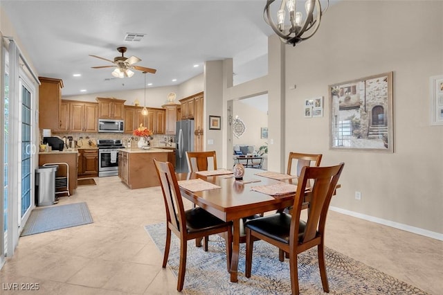 tiled dining area with vaulted ceiling, a wealth of natural light, and ceiling fan with notable chandelier