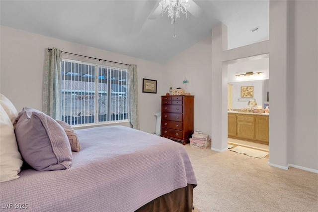 carpeted bedroom with ceiling fan, ensuite bathroom, and vaulted ceiling