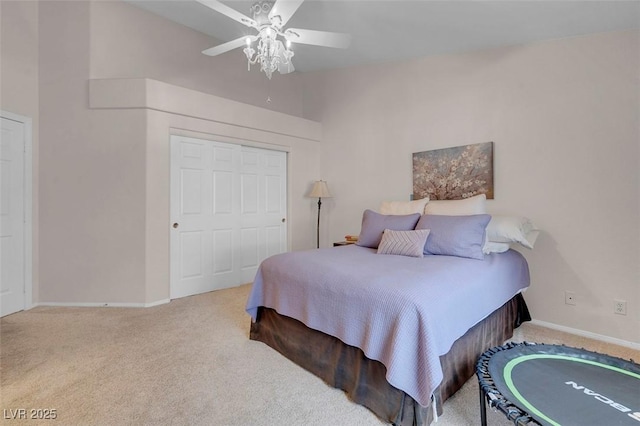 carpeted bedroom featuring a closet and ceiling fan