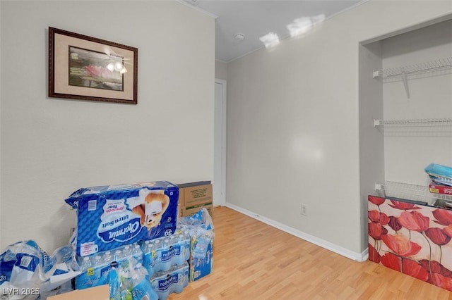 interior space featuring ornamental molding and wood-type flooring