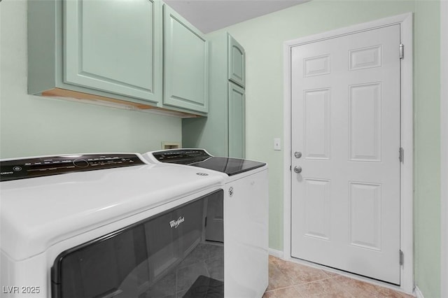 laundry room featuring light tile patterned flooring, cabinets, and washer and dryer