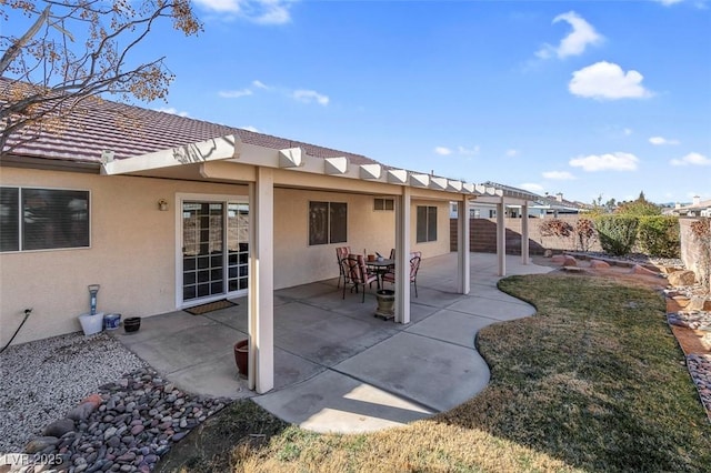 back of property featuring a patio area and a yard