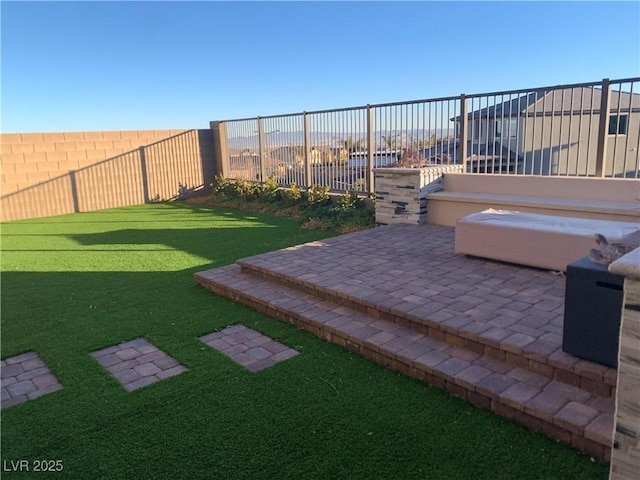 view of yard with a jacuzzi and a patio area