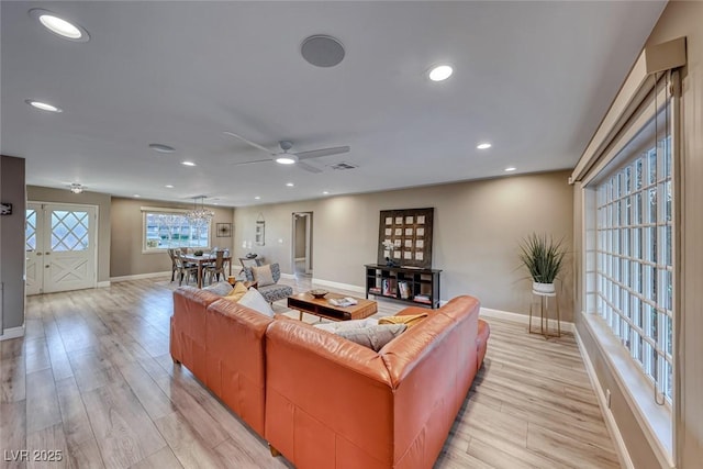 living room with light hardwood / wood-style flooring and ceiling fan