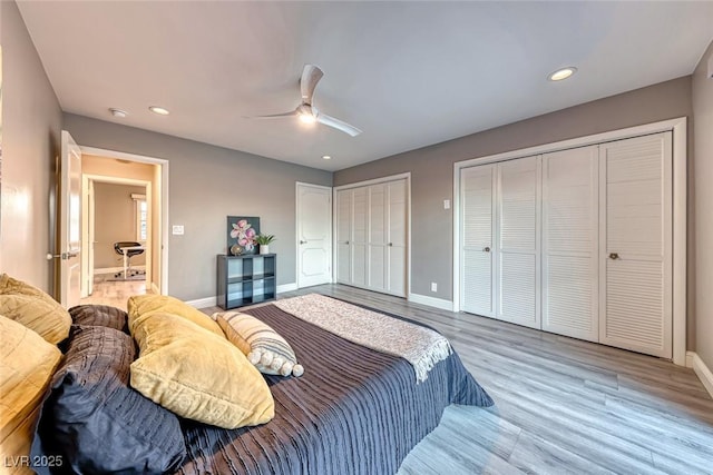 bedroom with multiple closets, ceiling fan, and hardwood / wood-style flooring