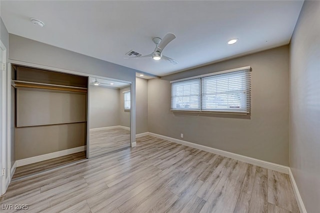 unfurnished bedroom with ceiling fan, a closet, and light hardwood / wood-style flooring