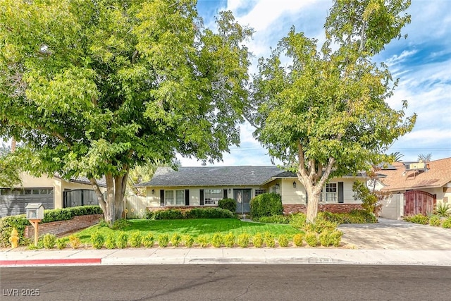 ranch-style home featuring a front yard