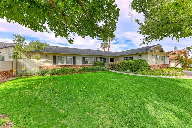 ranch-style home featuring a front yard