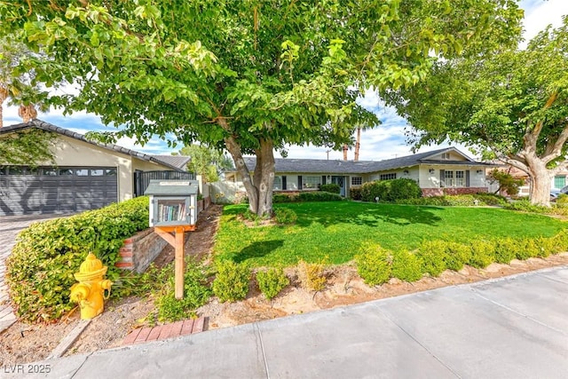 ranch-style house with a garage and a front lawn