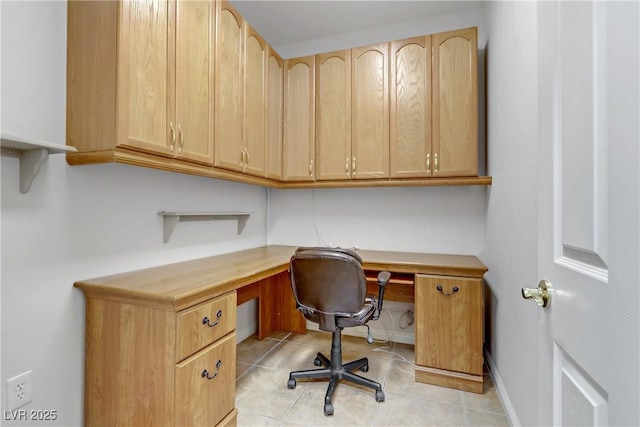 tiled office space featuring built in desk