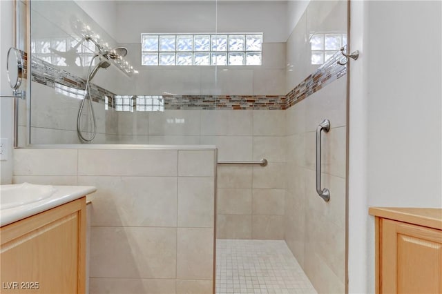 bathroom with vanity and tiled shower