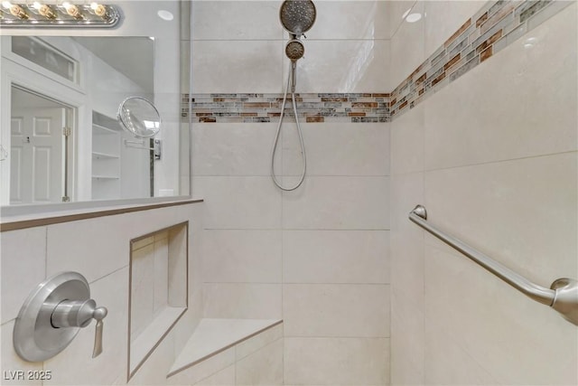 bathroom with a tile shower