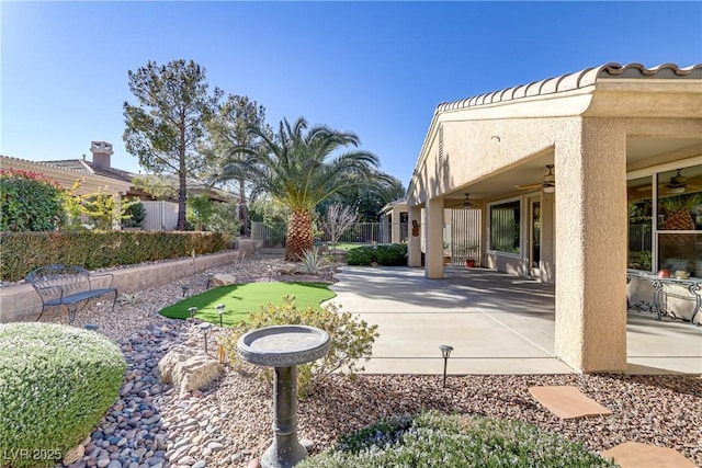 exterior space featuring ceiling fan and a patio