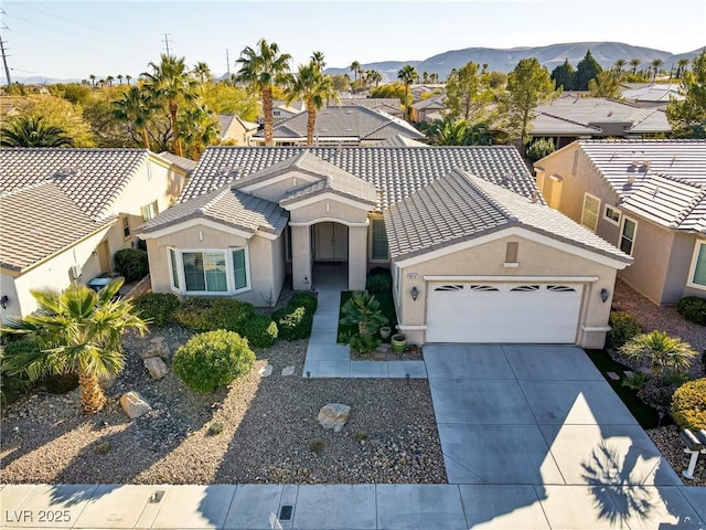 view of front of house with a mountain view and a garage