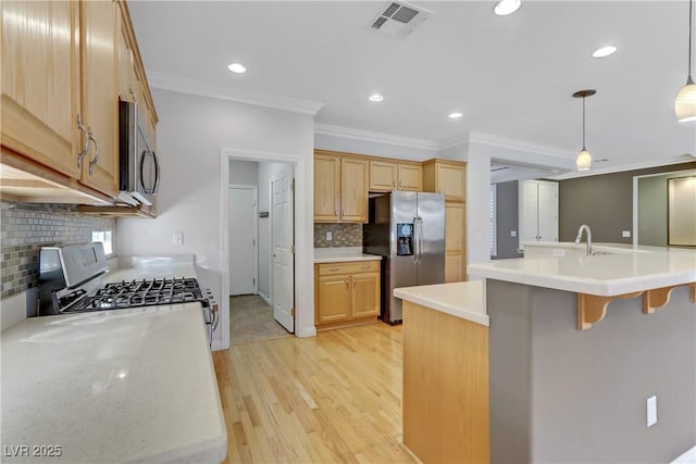 kitchen with pendant lighting, light brown cabinetry, appliances with stainless steel finishes, and crown molding