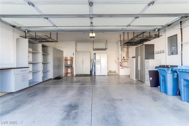 garage featuring white fridge with ice dispenser, electric panel, and a garage door opener