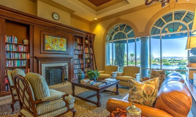 sitting room with ornamental molding and a towering ceiling