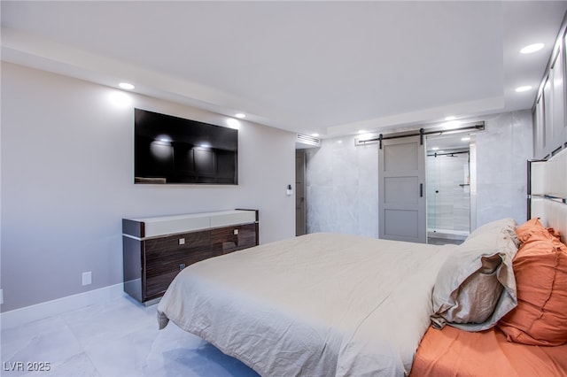 bedroom with a barn door and ensuite bathroom