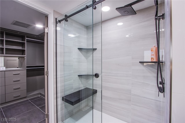 bathroom with tile patterned flooring and walk in shower