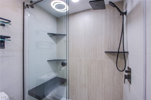 bathroom featuring a shower with door