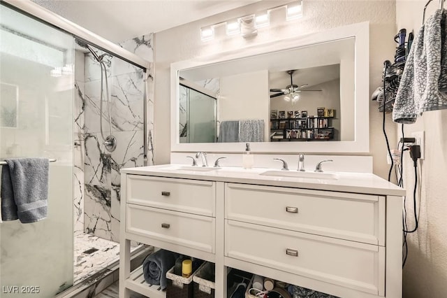 bathroom featuring ceiling fan, vanity, and an enclosed shower