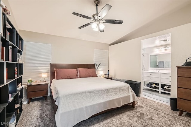 carpeted bedroom with ceiling fan and vaulted ceiling