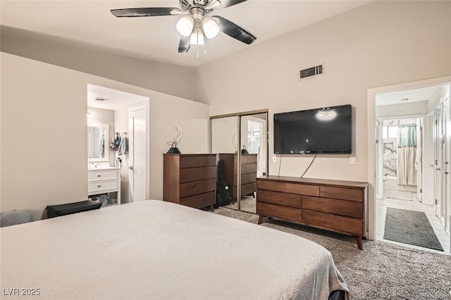 carpeted bedroom with lofted ceiling, a closet, and ceiling fan