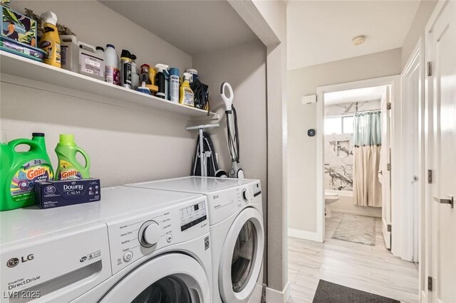 laundry room featuring laundry area, washer and clothes dryer, and baseboards