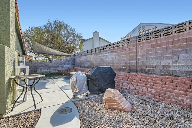 view of patio featuring a grill