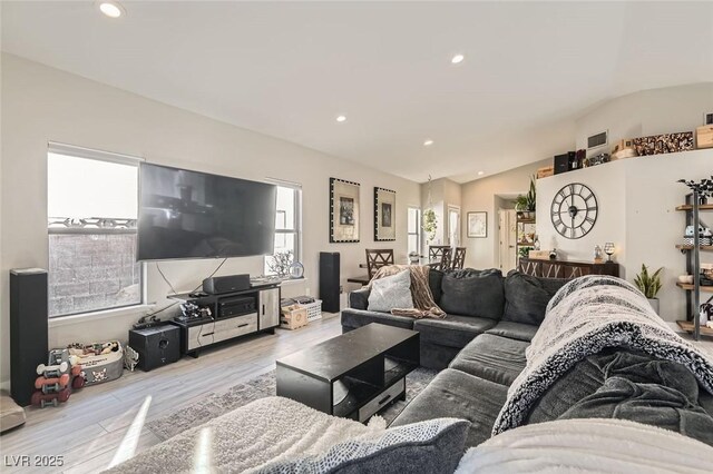 living area with lofted ceiling, light wood-type flooring, and recessed lighting