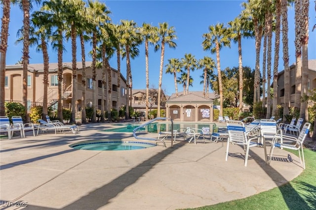 view of swimming pool featuring a community hot tub and a patio