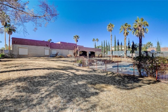 back of property featuring a fenced in pool