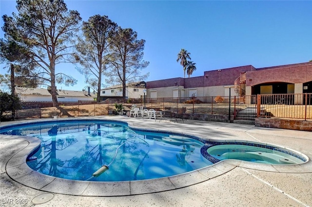 view of pool with an in ground hot tub and a patio area