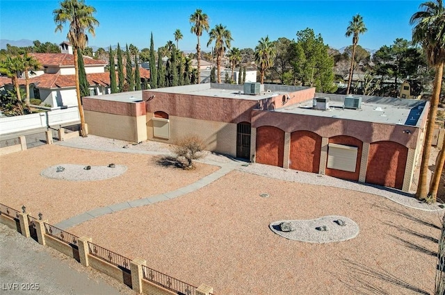 view of front of house with stucco siding and fence