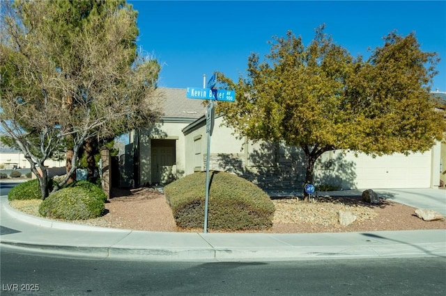 view of property hidden behind natural elements with a garage