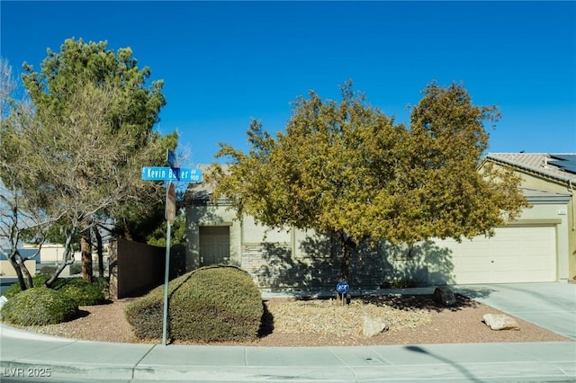 view of property hidden behind natural elements featuring a garage