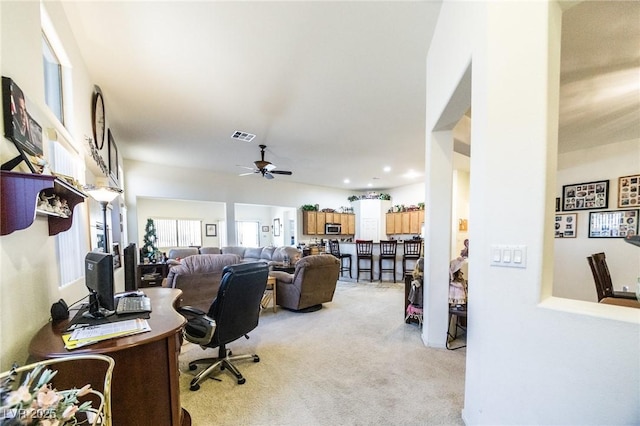 office space featuring ceiling fan and light colored carpet