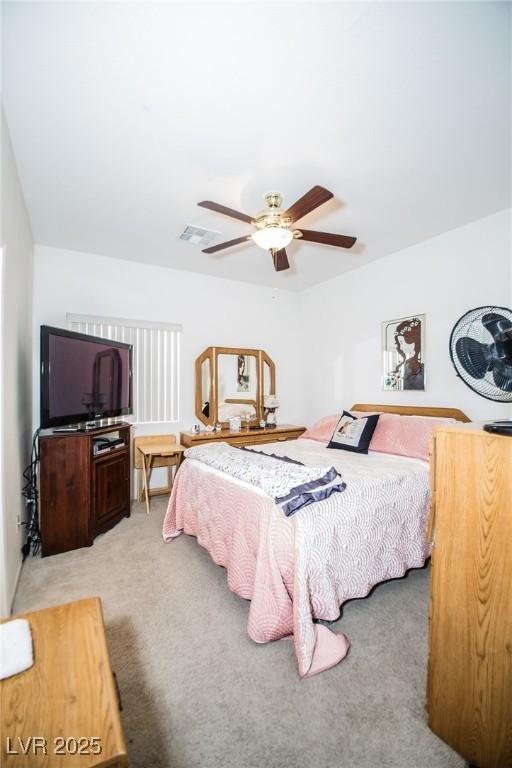 bedroom with ceiling fan and light carpet