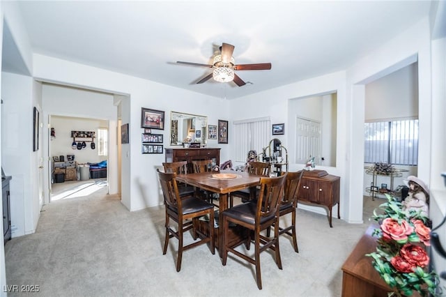 carpeted dining area featuring ceiling fan