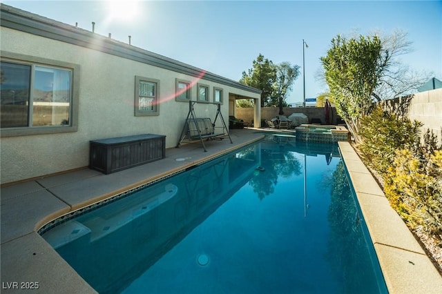 view of swimming pool with an in ground hot tub and a patio area