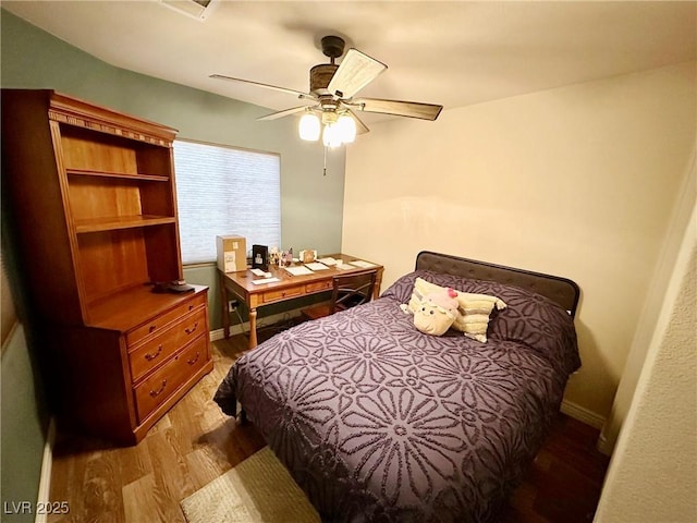 bedroom with light wood-type flooring and ceiling fan