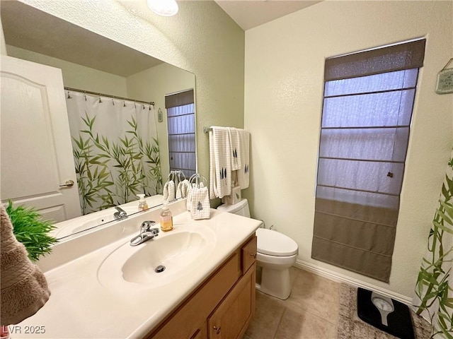 bathroom featuring vanity, toilet, and tile patterned floors