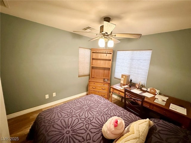 bedroom featuring ceiling fan and dark hardwood / wood-style floors