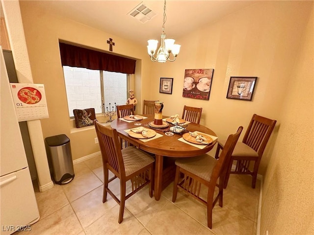 dining area featuring a notable chandelier and light tile patterned floors