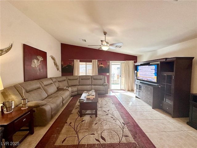 living room with lofted ceiling, ceiling fan, and light tile patterned floors