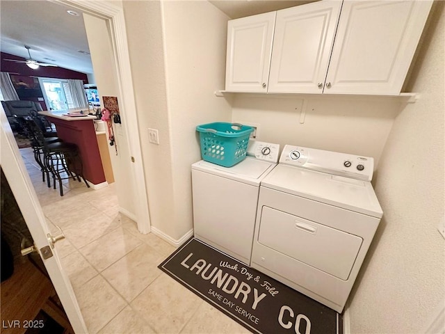 laundry room featuring ceiling fan, light tile patterned floors, separate washer and dryer, and cabinets