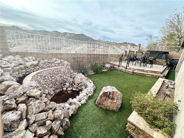 view of yard featuring a mountain view and a patio